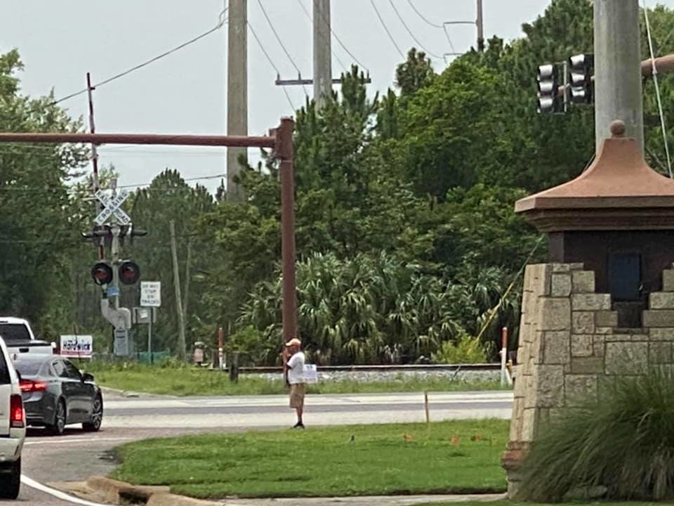 Peter Vigue walks along the roadside in St. Augustine seeking financial help from passersby.